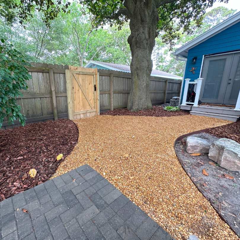 brown pea gravel making up backyard path