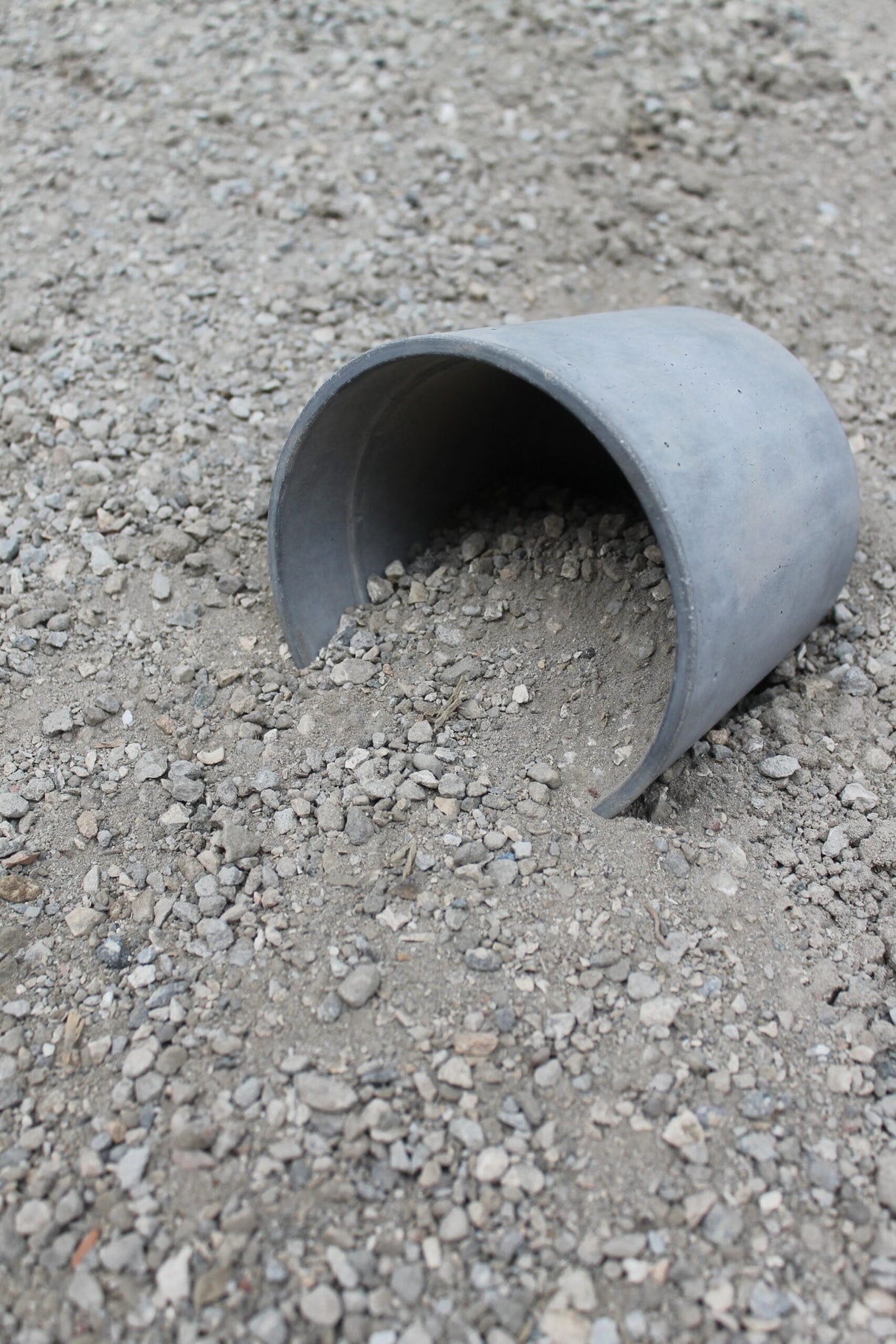 crushed concrete in bulk bin and compared to a bucket for scale