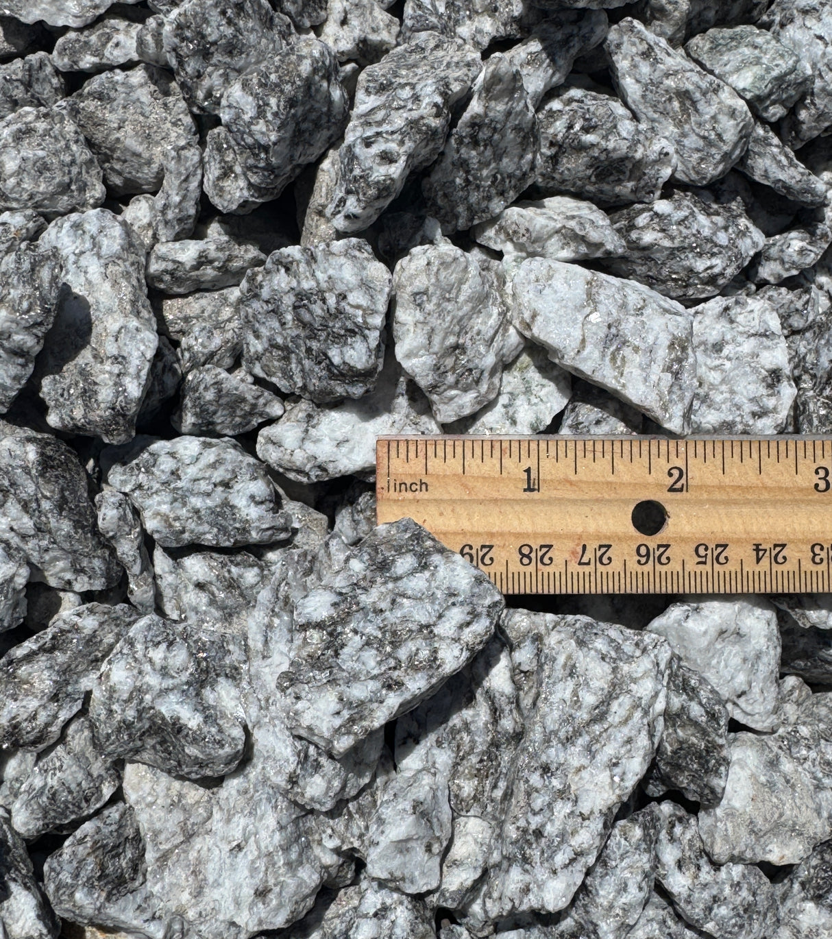 grey ice rock compared to ruler