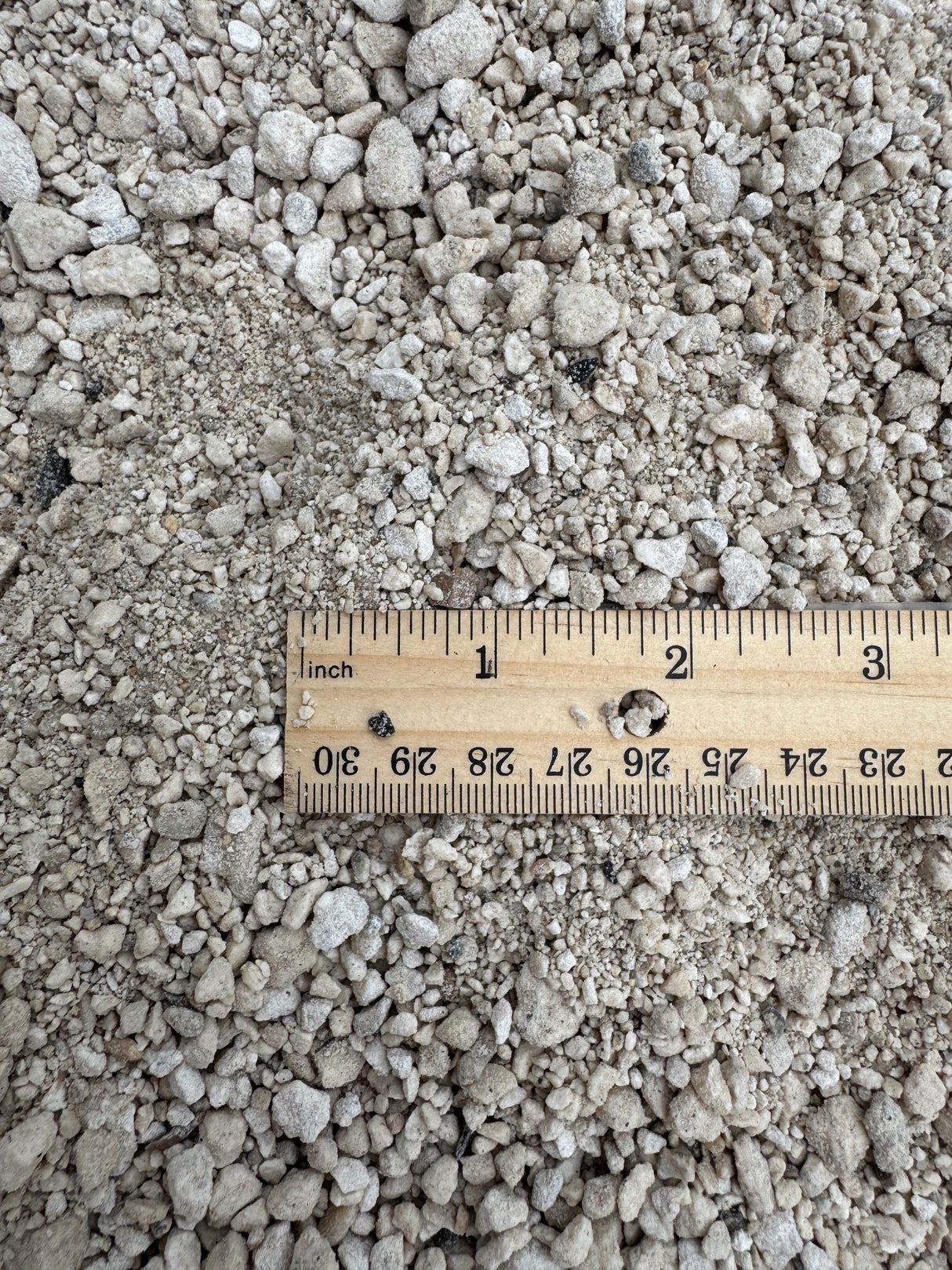 ruler compared to bin of limestone screenings