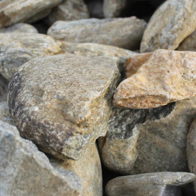 A pile of beige and brown river rock stones