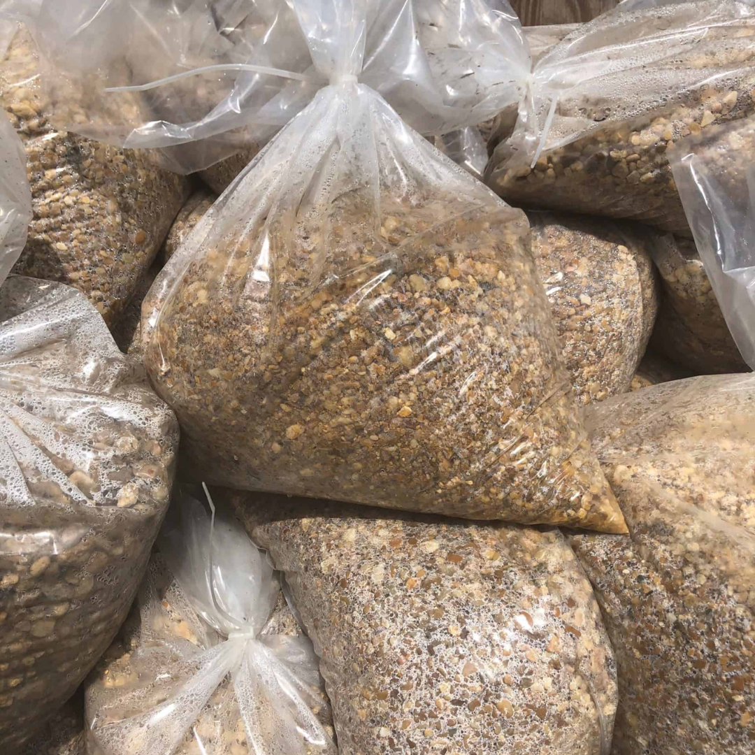 bags of brown pea gravel stacked in pile