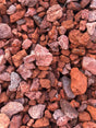 bright orange, grey, and deep red rocks in pile