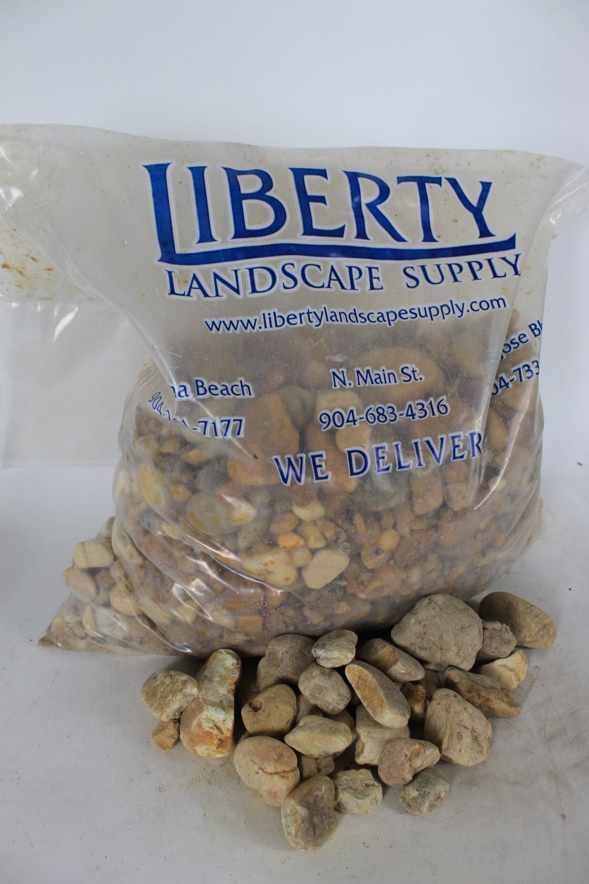 brown river rock in clear Liberty Landscape Supply bag