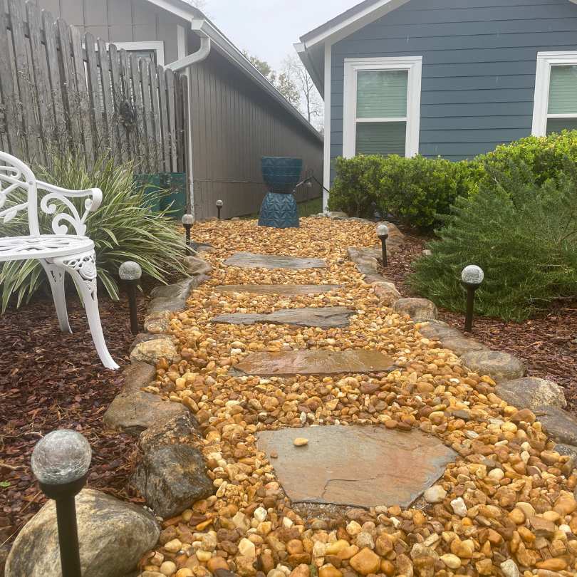 brown river rock making backyard pathway