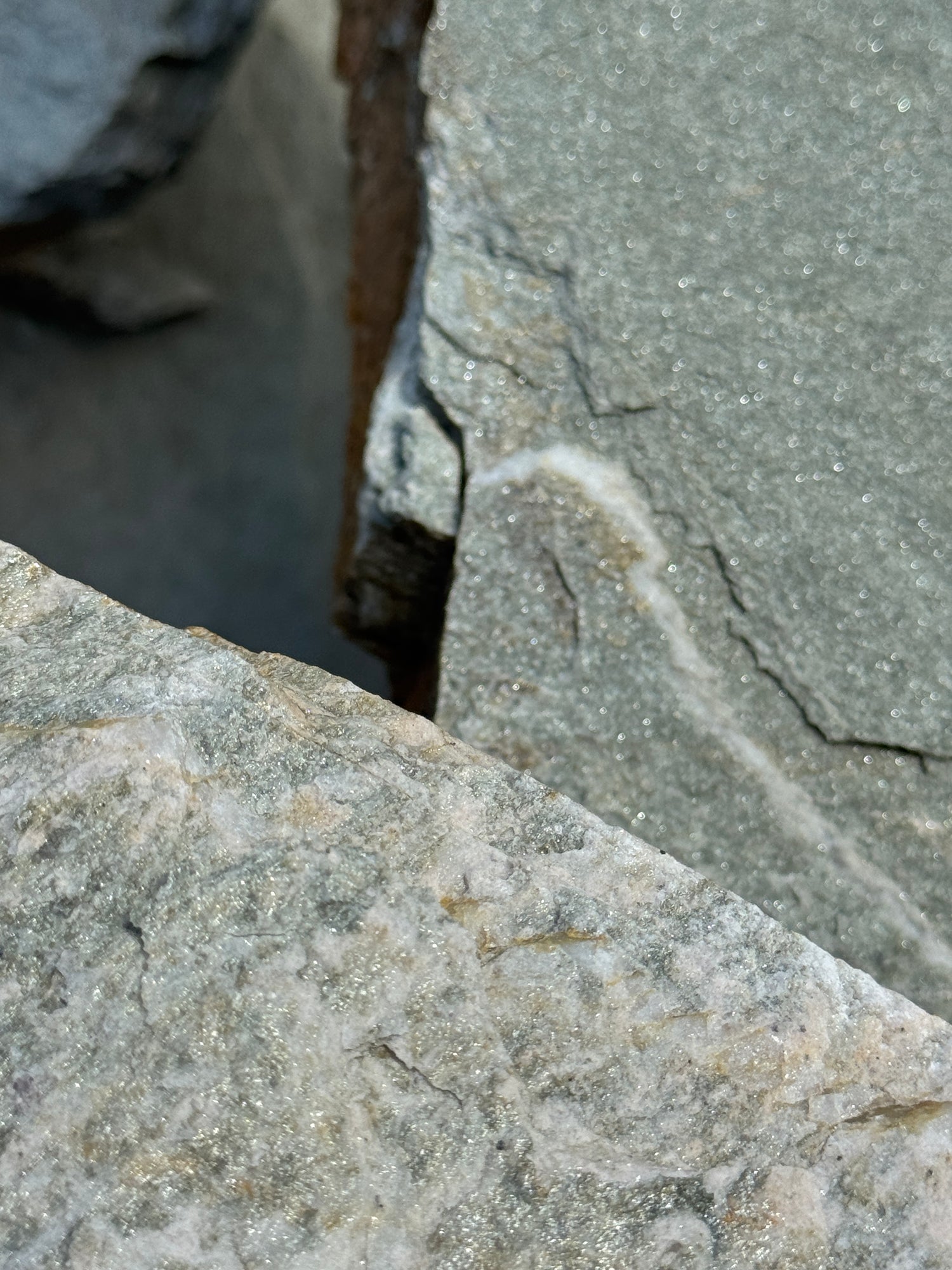 Close-up of textured flagstone surface with shine and natural patterns