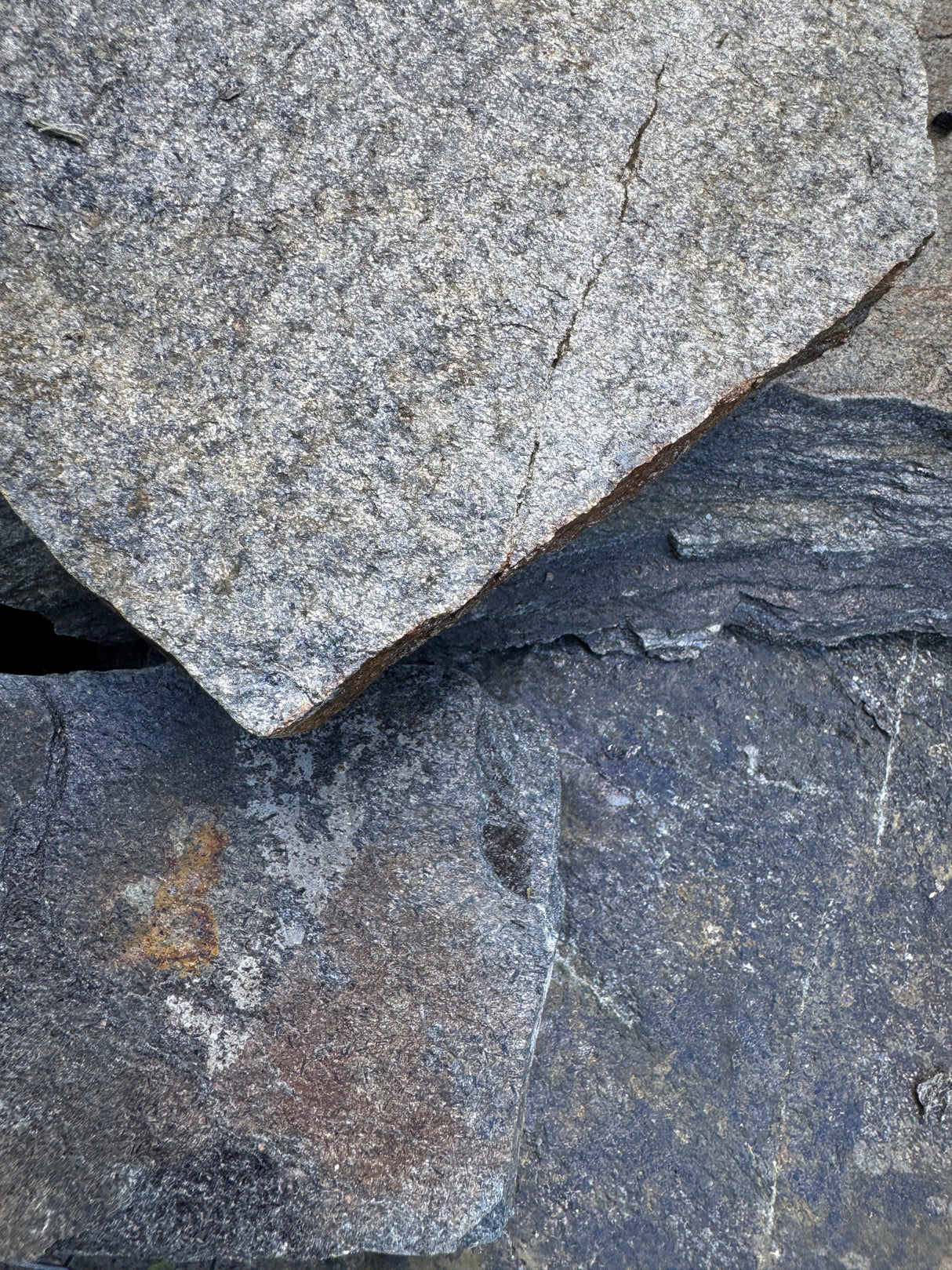 Close-up of textured silver stones with visible patterns.