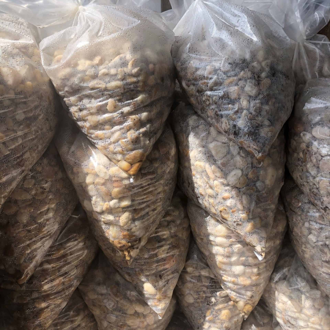 clear bags of white river rock stacked four high