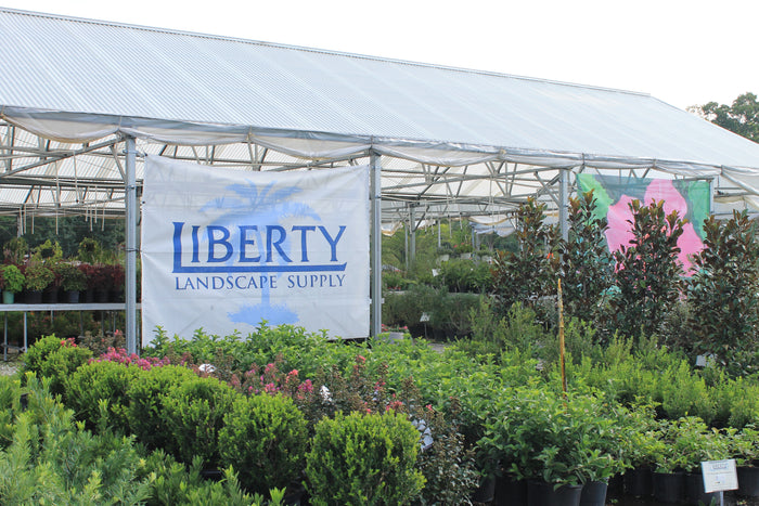 Liberty Landscape Supply greenhouse with plants and signage