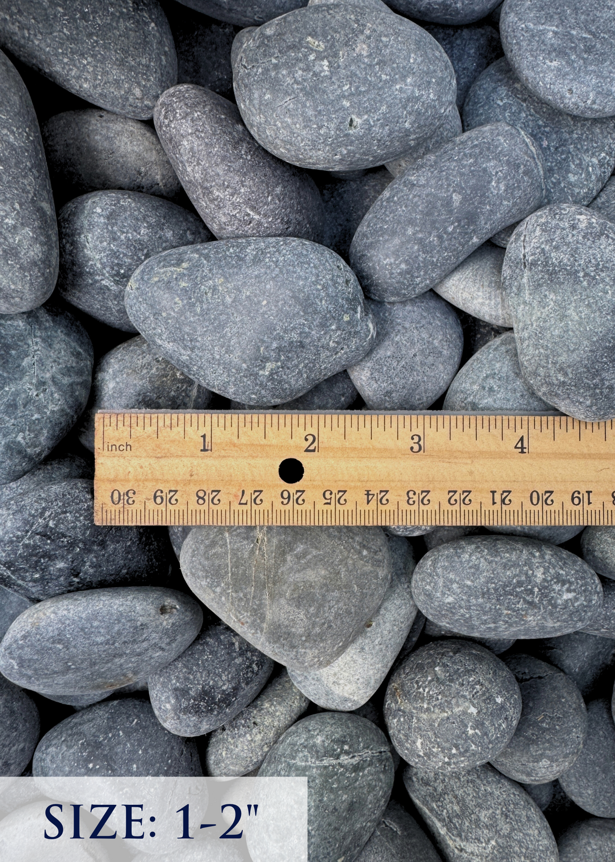 Gray pebbles with a ruler indicating size 1-2 inches
