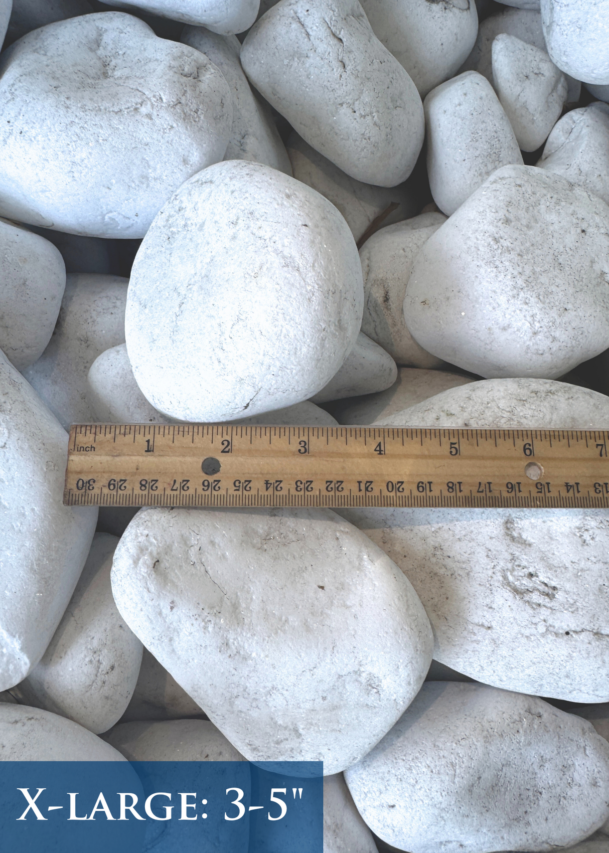 White Santorini stones with a ruler indicating their size as 3 to 5 inches