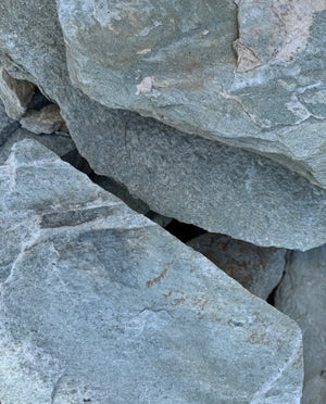 Close-up of gray-green stone blocks with visible texture