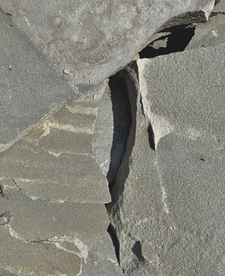 Close-up of textured blue gray flagstone surface with patterns