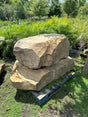 two large Tennessee boulders placed on a pallet in a garden setting