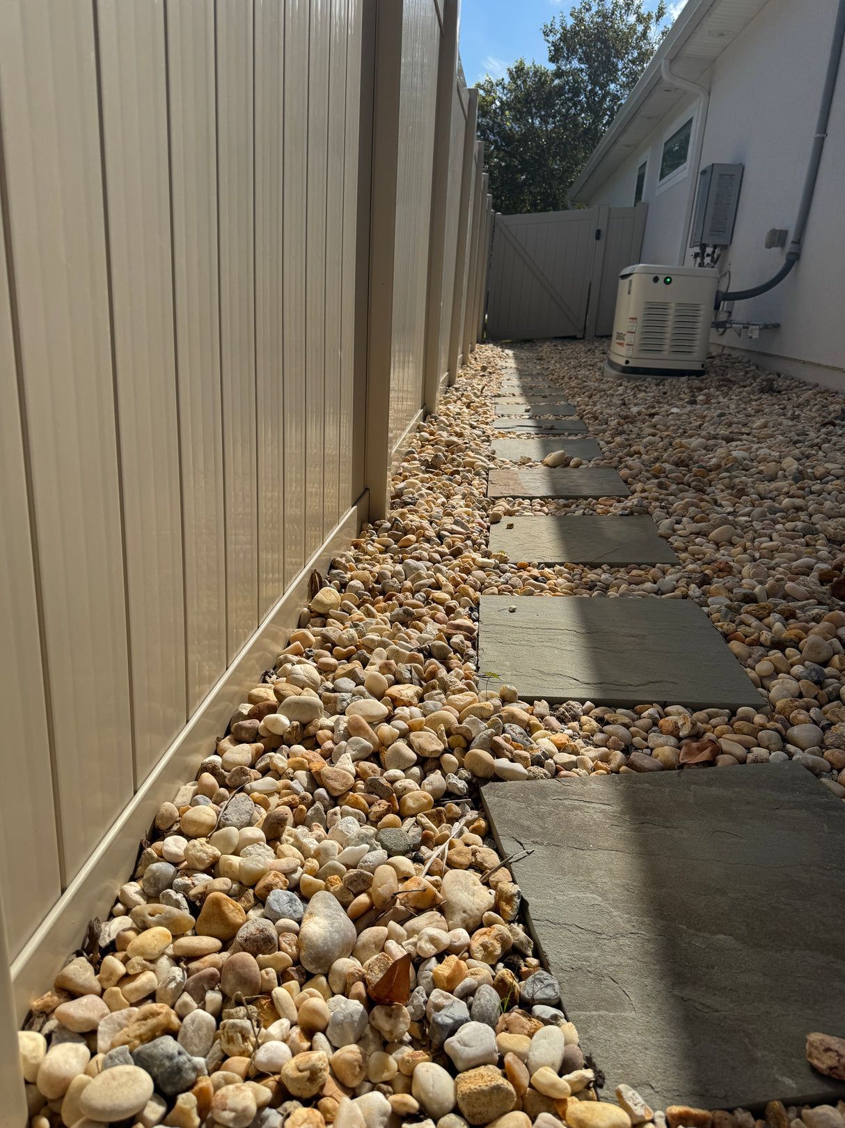 Outdoor wall with stone veneer and air conditioning unit